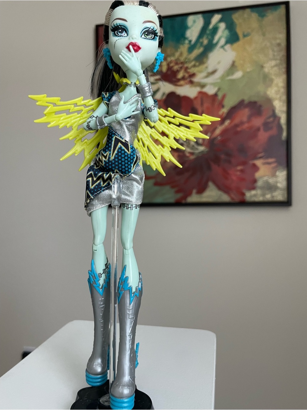 monster high doll with yellow lightning wings and silver outfit